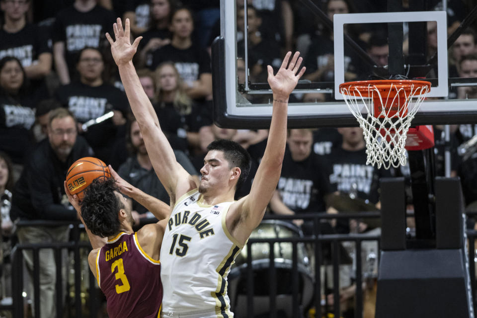Minnesota forward Dawson Garcia (3) attempts to shoot while defended by Purdue center Zach Edey (15) during the second half of an NCAA college basketball game, Sunday, Dec. 4, 2022, in West Lafayette, Ind. (AP Photo/Doug McSchooler)