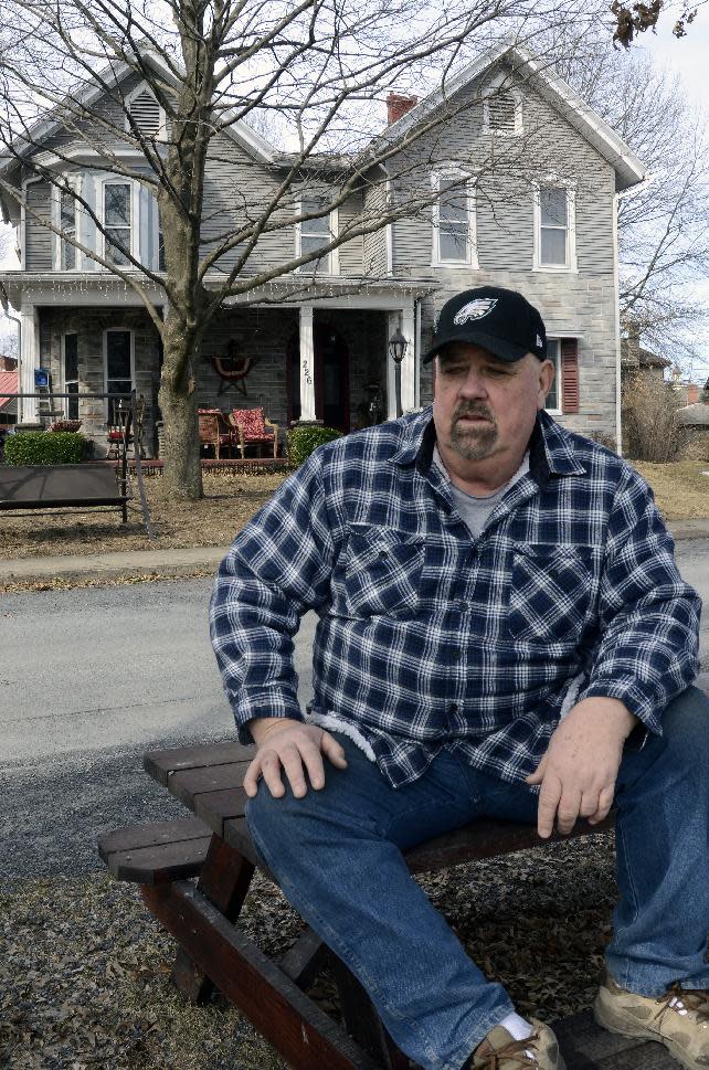 Paul Garrett sits in front of his home in Jersey Shore, Pa. on Sunday March 23, 2014. With an expected increase in flood insurance rates, he says, "It's going to turn the towns that are on the river into ghost towns. Because nobody's going to want to pay that. Nobody's going to want to live here. Property values are going to plummet." (AP Photo/Ralph Wilson)