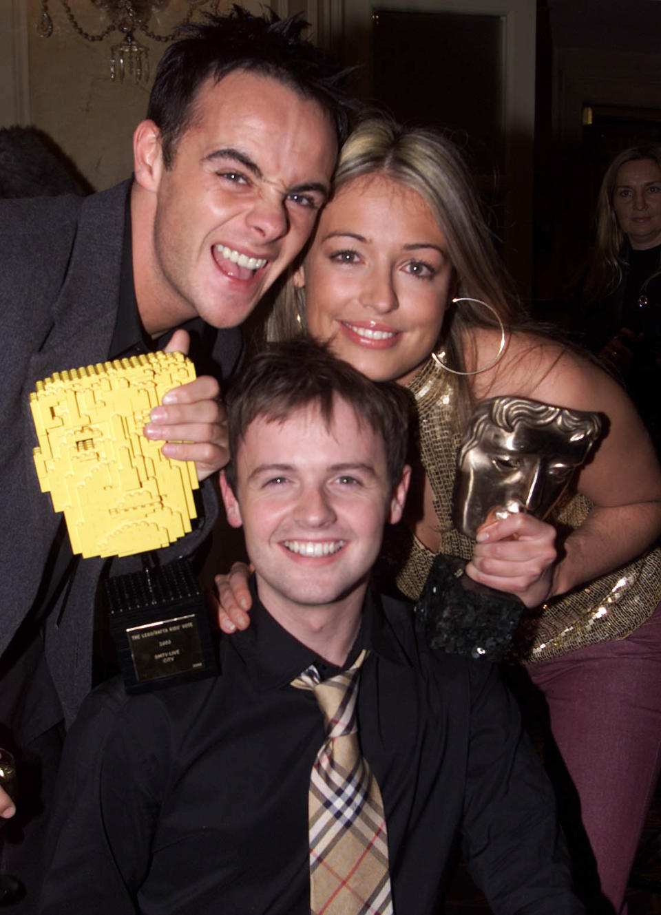 TV presenters Ant and Dec (Ant McPartlin (L) and Declan Donnelly (C)) and Cat Deeley (R) at the British Academy Children's Film & Television Awards at the Park Lane Hilton, London on 24 November, 2002. SM:TV won Best Entertainment Award and the Lego Kid's Vote award. (Photo by Gareth Davies/Getty Images)