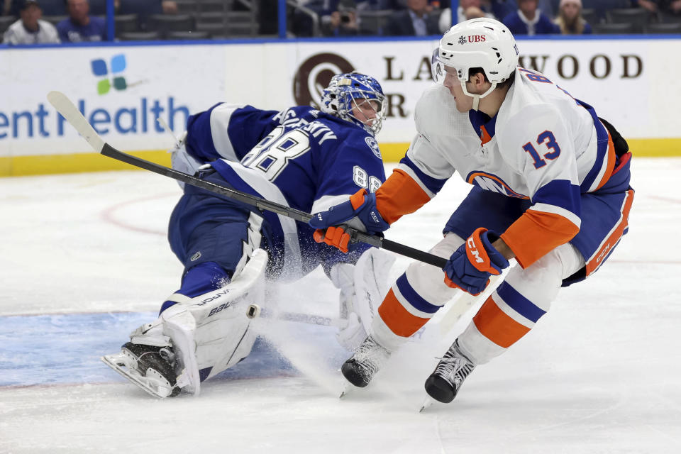 New York Islanders' Mathew Barzal (13) scores past Tampa Bay Lightning goaltender Andrei Vasilevskiy during the first period of an NHL hockey game Monday, Nov. 15, 2021, in Tampa, Fla. (AP Photo/Mike Carlson)