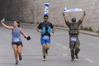 Runners compete in the Jerusalem Winner Marathon, in Jerusalem, Friday, March 8, 2024. (AP Photo/Ohad Zwigenberg)