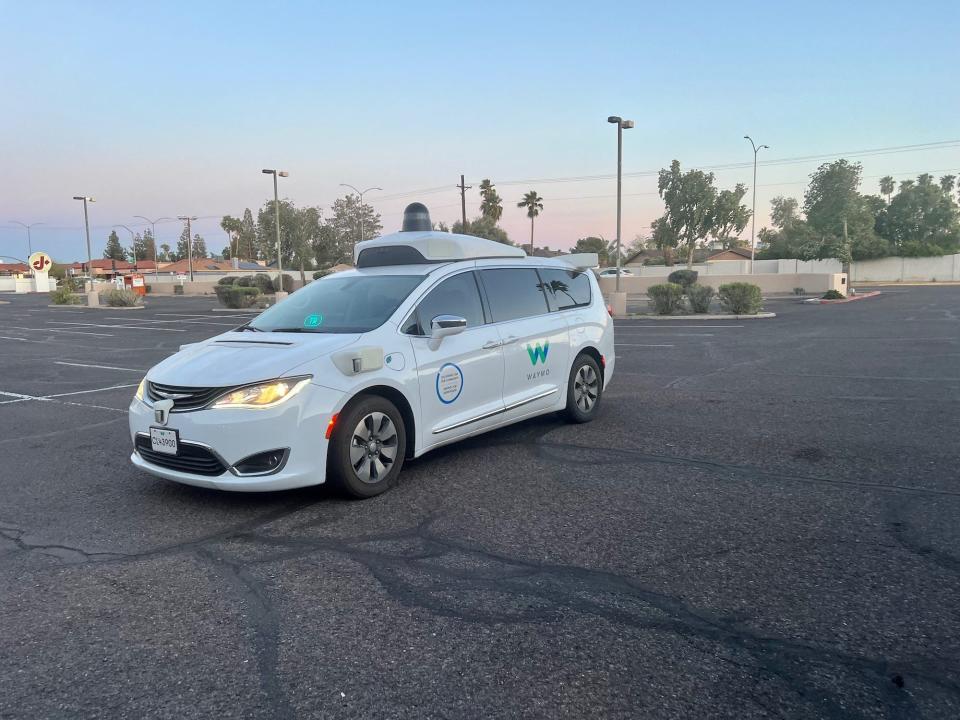 The Waymo car in the parking lot of the salon.