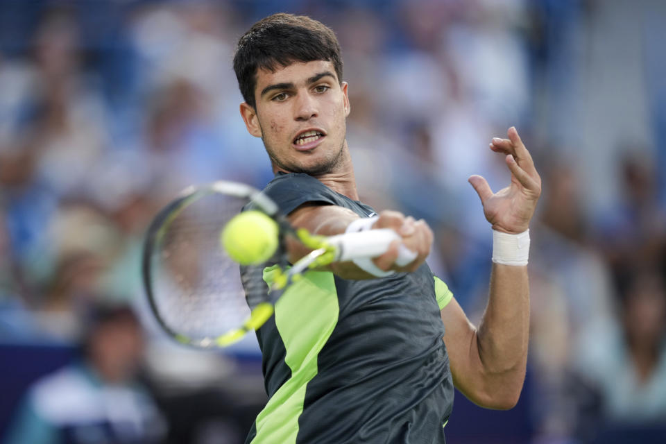 Carlos Alcaraz, of Spain, returns a shot to Novak Djokovic, of Serbia, during the men's singles final of the Western & Southern Open tennis tournament, Sunday, Aug. 20, 2023, in Mason, Ohio. (AP Photo/Aaron Doster)