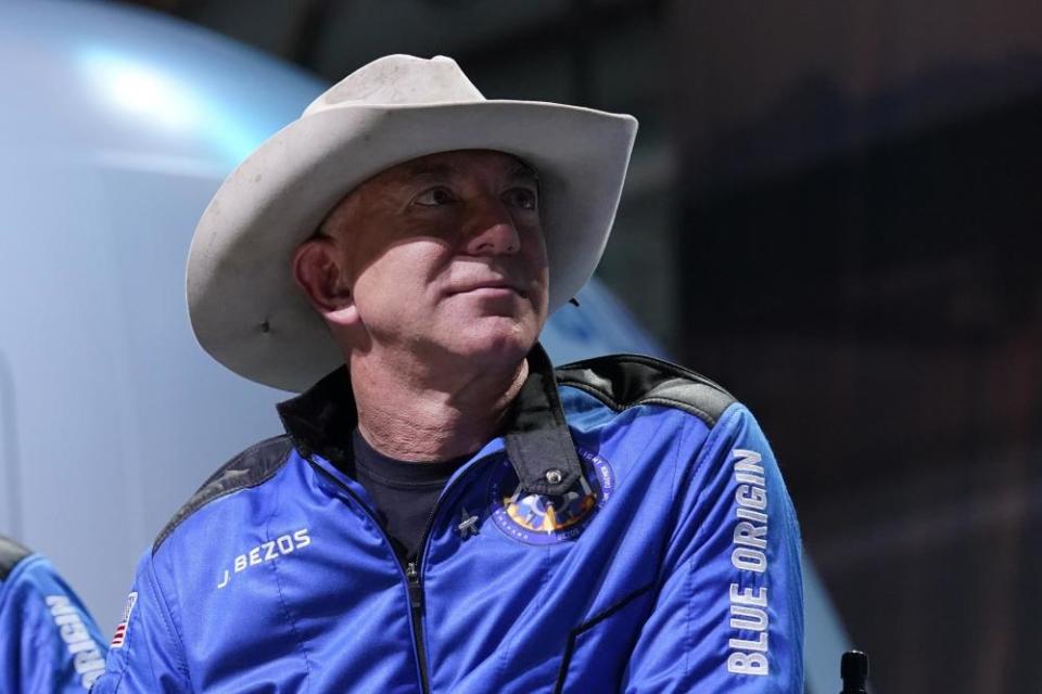 Jeff Bezos wears a Blue Origins jacket and a cowboy hat during a post launch briefing on 20 July.