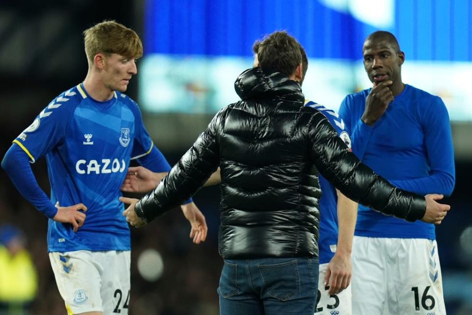 A supporter remonstrates with Everton’s Anthony Gordon and Abdoulaye Doucoure (AP)