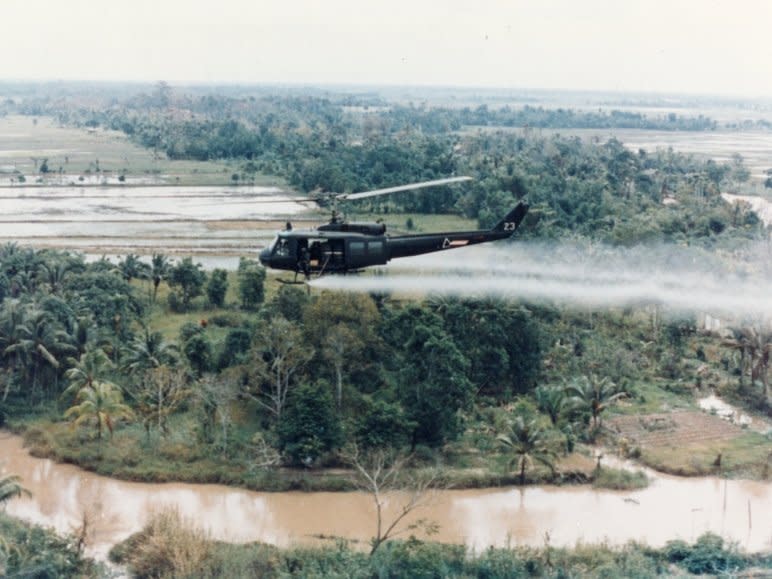 US Huey helicopter spraying Agent Orange in Vietnam