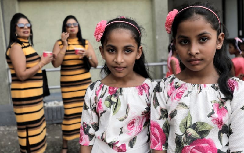 Twins pose for photographs during an event to attempt to break the world record for the biggest gathering of twins in Colombo