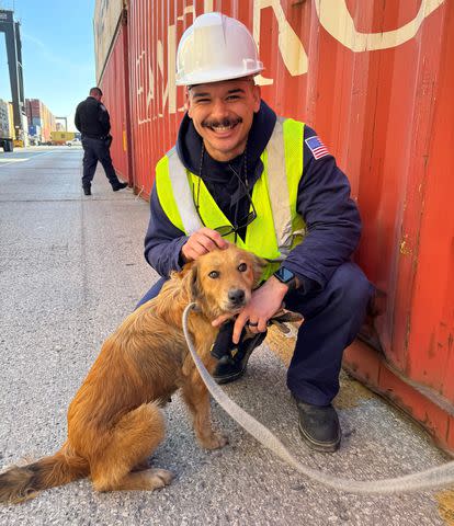 <p>U.S. Coast Guard Heartland/Facebook</p> Connie the Container Dog with one of the U.S. Coast Guard inspectors that rescued her from a shipping container