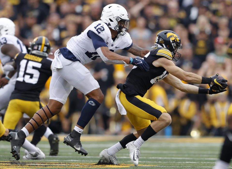 Iowa wide receiver Charlie Jones (16) makes a reception in front of Penn State linebacker Brandon Smith (12) during the first half of an NCAA college football game, Saturday, Oct. 9, 2021, in Iowa City, Iowa. (AP Photo/Matthew Putney)