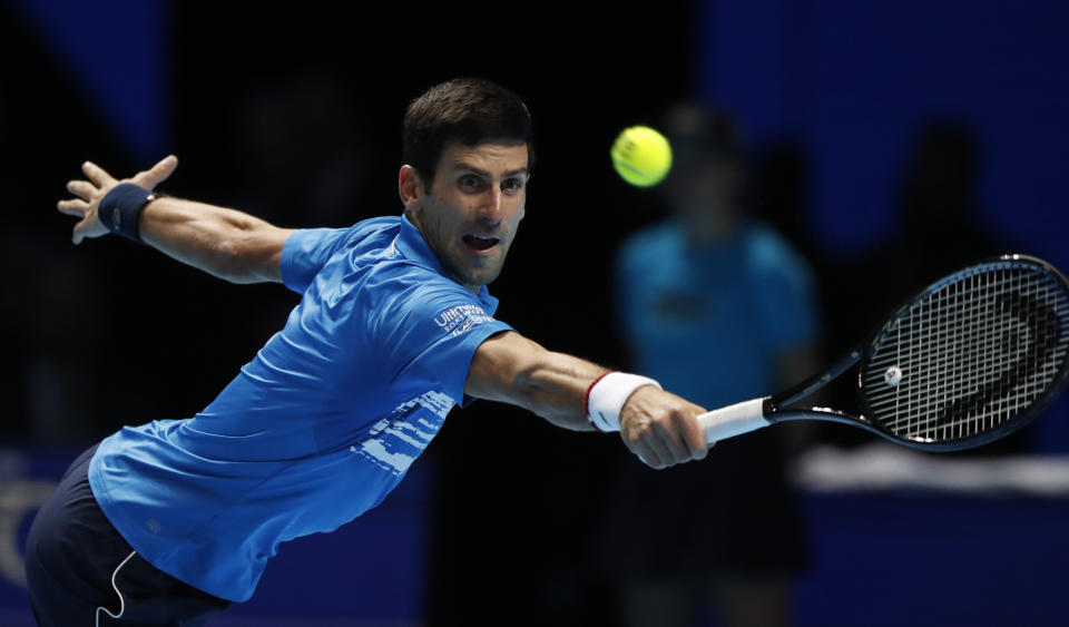 Serbia's Novak Djokovic plays a return to Austria's Dominic Thiem during their ATP World Tour Finals singles tennis match at the O2 Arena in London, Tuesday, Nov. 12, 2019. (AP Photo/Alastair Grant)