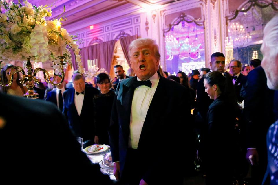 Donald Trump wears a tuxedo at a New Year's Eve party he hosted at his Mar-a-Lago resort.