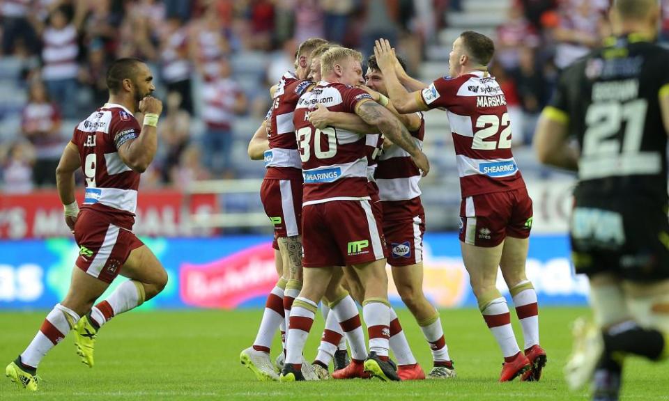 Josh Woods and his Wigan teammates celebrate after the late drop goal