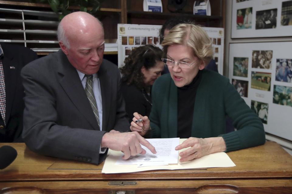 New Hampshire Secretary of State Bill Gardner instructs Democratic presidential candidate U.S. Sen. Elizabeth Warren, D-Mass., as she files to have her name listed on the New Hampshire primary ballot, Wednesday, Nov. 13, 2019, in Concord, N.H. (AP Photo/Charles Krupa)