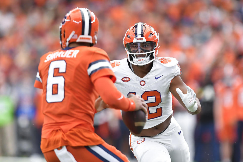 Clemson defensive end T.J. Parker, right, pressures Syracuse quarterback Garrett Shrader during the first half of an NCAA college football game in Syracuse, N.Y., Saturday, Sept. 30, 2023. (AP Photo/Adrian Kraus)