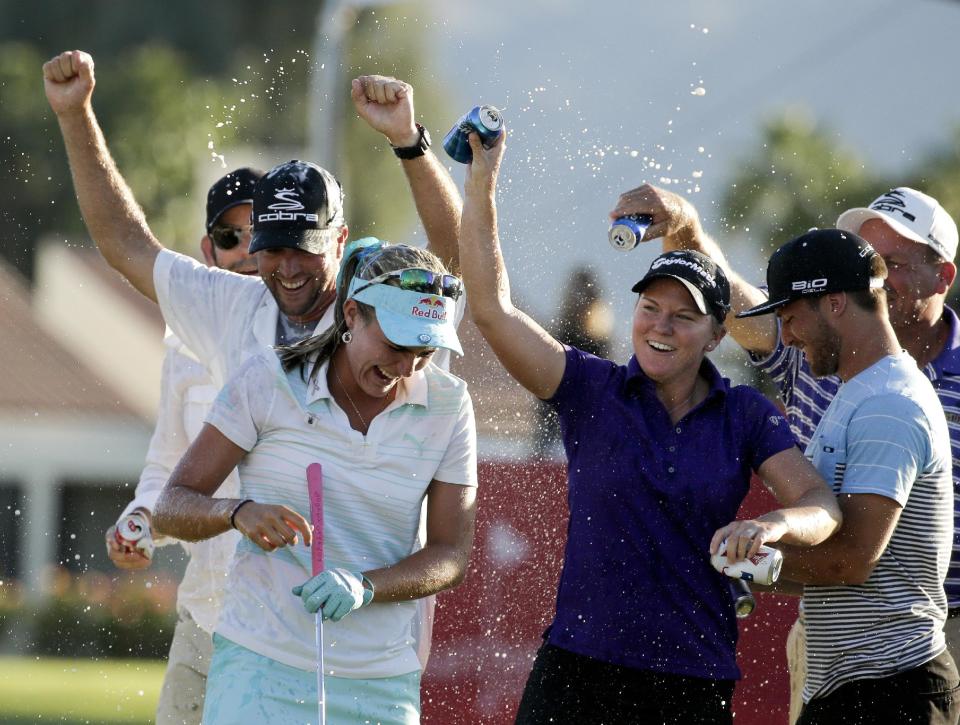 Lexi Thompson smiles and is showered after winning the Kraft Nabisco Championship golf tournament Sunday, April 6, 2014, in Rancho Mirage, Calif. (AP Photo/Chris Carlson)