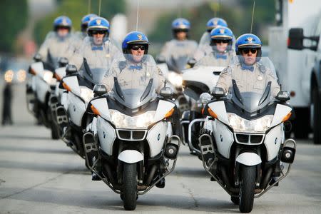 California Highway Patrol officers arrive at a memorial service of San Bernardino shooting victim Yvette Velasco in Covina, California December 10, 2015. REUTERS/Mike Blake