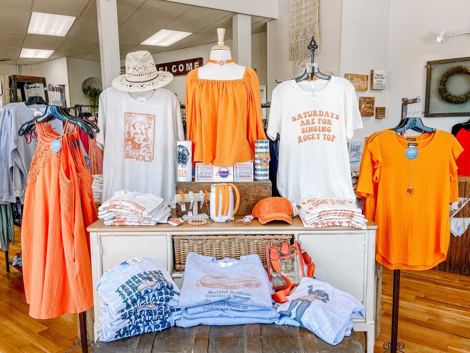 Folly Boutique owner Becky Walker always tries to source as much orange apparel for her customers as she can. Fountain City, Aug. 18, 2022.