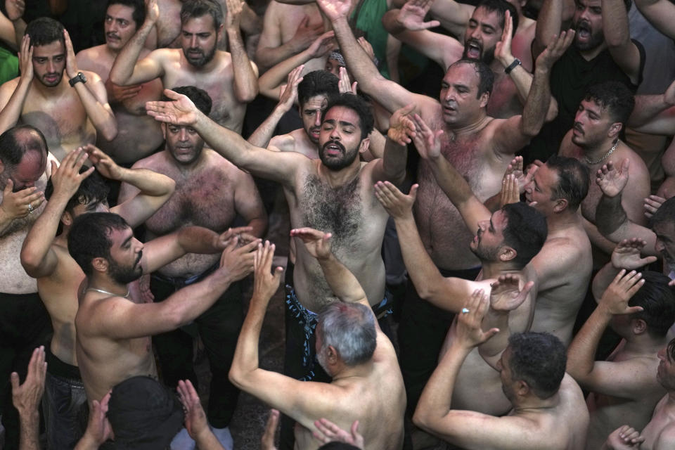 Shiite Muslims beat their heads and chests during the Ashoura mourning ritual, Friday, July 28, 2023, n Tehran, Iran. Millions of Shiite Muslims in Iran, Afghanistan, Pakistan and around the world on Friday commemorated Ashoura, a remembrance of the 7th-century martyrdom of the Prophet Muhammad's grandson, Hussein, that gave birth to their faith. (AP Photo/Vahid Salemi)