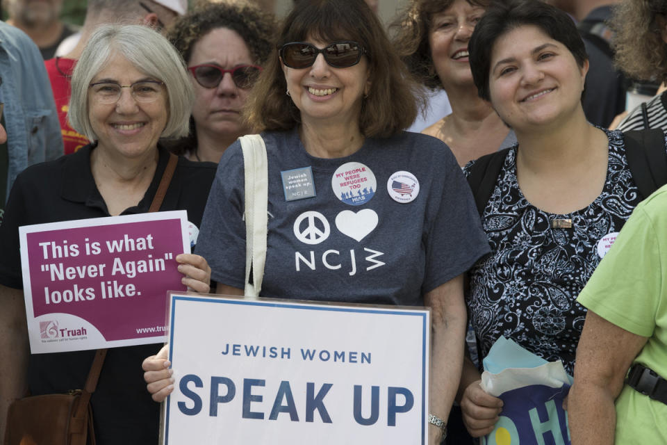 <span class="icon icon--xs icon__camera">  </span> <span class="credit font--s-m upper black"> <b>Jose Moreno</b> </span> <div class="caption space-half--right font--s-m gray--med db"> People gathered during an immigration protest outside of the United States Custom House. </div>