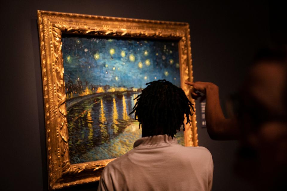 A young visitor ponders "Starry Night Over the Rhone" at the "Van Gogh in America" exhibit earlier this year at the DIA.