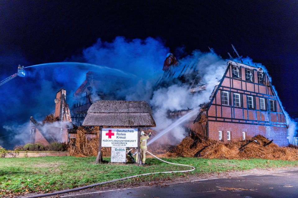 Firefighters extinguish the fire in a hotel where refugees from Ukraine were accommodated in Gross Stroemkendorf, Germany, on Oct.20.<span class="copyright">Jens Büttner—dpa/AP</span>