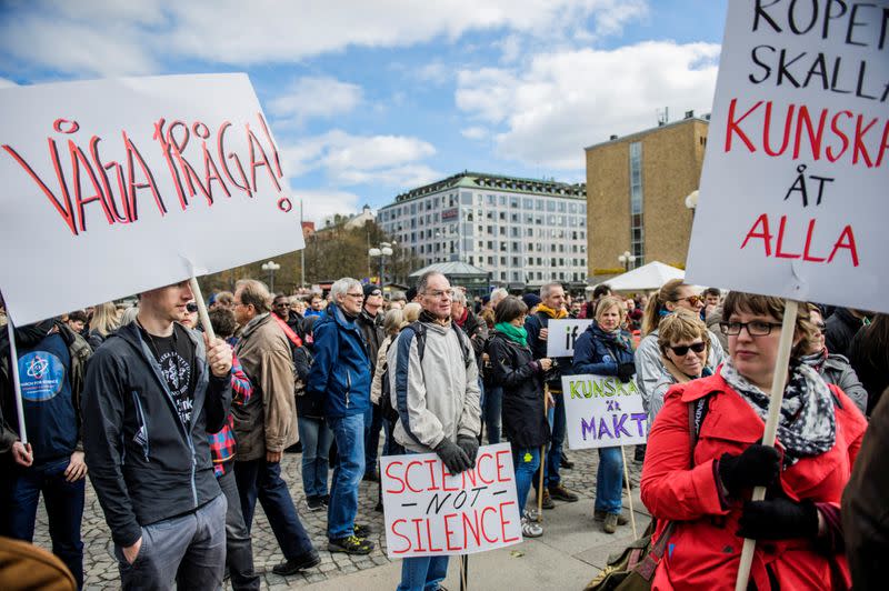 Demonstrators hold placards during the "March for Science Stockholm" manifestation at Medborgarplatsen square in Stockholm