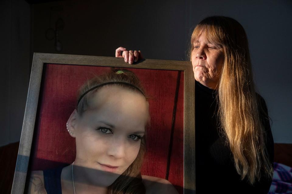 Missy Kerridge, the mother of Sadie Overland, holds a portrait of her daughter as she stands inside her home in Germfask on Wednesday, Nov. 29, 2023.