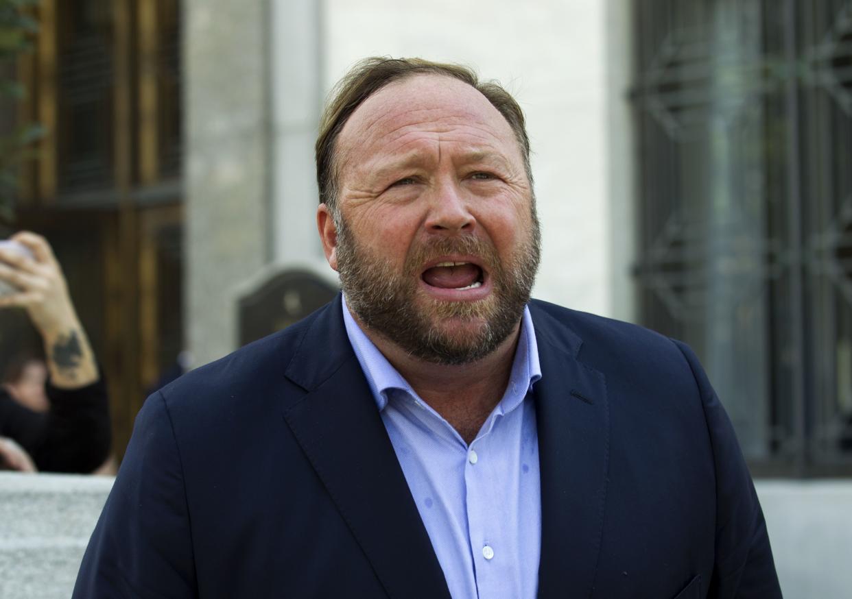 Alex Jones speaks to reporters in Washington, Sept. 5, 2018. Infowars filed for Chapter 11 bankruptcy protection on Sunday, April 17, 2022, in Texas as its founder and conspiracy theorist Alex Jones faces defamation lawsuits over his comments that the Sandy Hook Elementary School shooting was a hoax. 