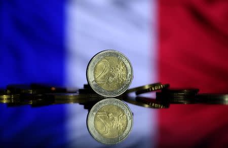 Euro coins are seen in front of displayed France flag in this picture illustration taken May 7, 2017. REUTERS/Dado Ruvic/Illustration