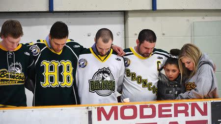 Mourners embrace each other during a moment of prayer at a vigil at the Elgar Petersen Arena, home of the Humboldt Broncos, to honour the victims of a fatal bus accident in Humboldt, Saskatchewan, Canada April 8, 2018. Jonathan Hayward/Pool via REUTERS