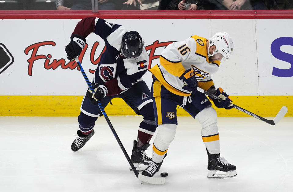 Colorado Avalanche center Casey Mittelstadt, left, and Nashville Predators left wing Jason Zucker work for the puck during the third period of an NHL hockey game Saturday, March 30, 2024, in Denver. (AP Photo/David Zalubowski)