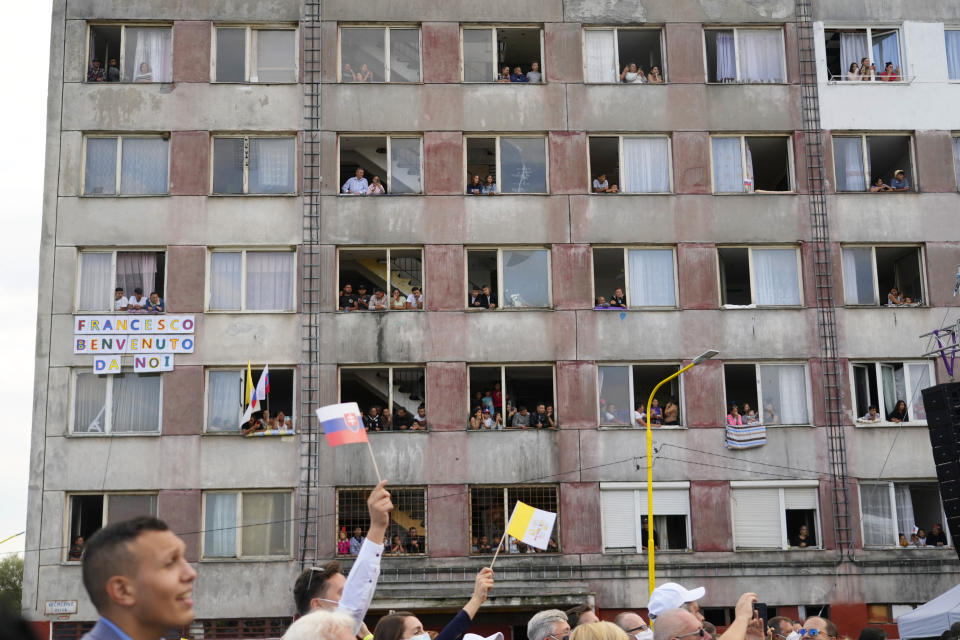 Residents wait for Pope Francis arrival to meet members of the Roma community at Lunik IX, in Kosice, Slovakia, Tuesday, Sept. 14, 2021, the biggest of about 600 shabby, segregated settlements where the poorest 20% of Slovakia's 400,000 Roma live. Pope Francis traveled to Kosice, in the far east of Slovakia on Tuesday to meet with the country's Roma in a gesture of inclusion for the most socially excluded minority group in Slovakia, who have long suffered discrimination, marginalization and poverty. (AP Photo/Gregorio Borgia)