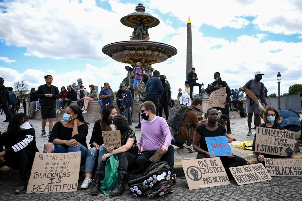 People with placards reading 'Black Lives Matter', 'no justice no peace', gather on the place de la Concorde, near the US embassy compound, in Paris on June 6, 2020, during a rally called as part of a weekend of global rallies worldwide against racism and police brutality in the wake of the death of George Floyd, an unarmed black man killed while apprehended by police in Minneapolis, US. - Police banned the rally as well as a similar second one on the Champs de Mars park facing the Eiffel Tower today, saying the events were organised via social networks without official notice or consultation. But on June 2, another banned rally in Paris drew more than 20000 people in support of the family of Adama Traore, a young black man who died in police custody in 2016. (Photo by Anne-Christine POUJOULAT / AFP) (Photo by ANNE-CHRISTINE POUJOULAT/AFP via Getty Images)