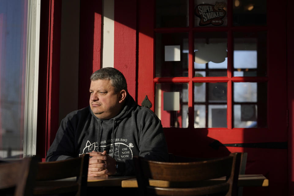Jeff Fitter, owner of Super Smokers BBQ, poses for a photo inside his restaurant Thursday, Jan. 28, 2021, in Eureka, Mo. Fitter says his profits were down by about half last year, largely because of the closures and capacity limits imposed by St. Louis County. He is supporting a bill that would limit local emergency health orders to 14 days unless authorized for longer by the Legislature. (AP Photo/Jeff Roberson)