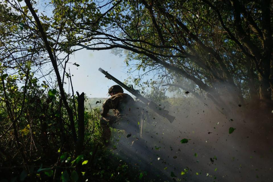 Members of the SPG-9 anti tank recoilless gun crew fires the gun onto Russian positions near the occupied Ukrainian city of Bakhmut on August 14, 2023 in Donetsk Oblast, Ukraine. Bakhmut and its surroundings continue to be places of most fierce battles since the beginning of the full-scale Russian invasion. Ukrainian infantry, leading the counteroffensive and directly engaging in ground combats with the enemy, is always supported by tanks and artillery. (Roman Chop/Global Images Ukraine via Getty Images)