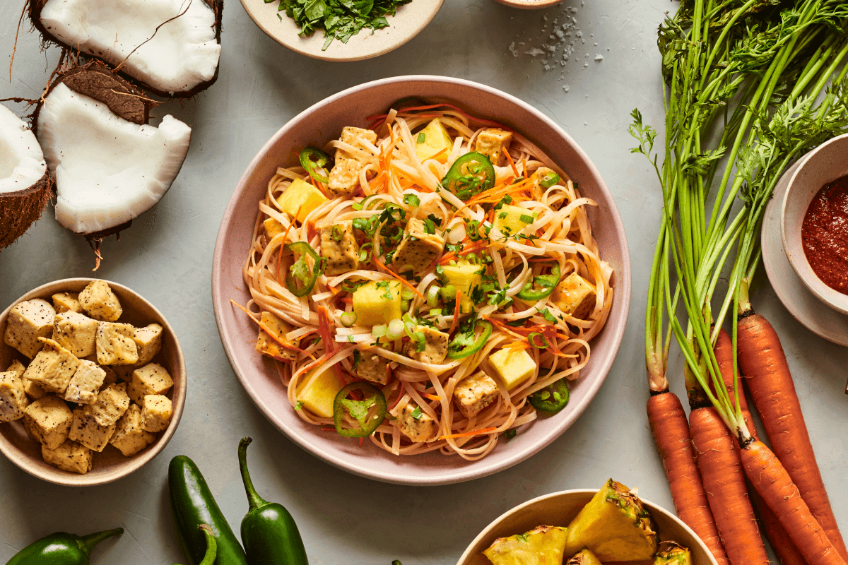 Red coconut curry stir-fry, available at honeygrow, is made with red coconut curry sauce, rice noodles, roasted tofu, pineapples, jalapeños, carrots, scallions and cilantro.