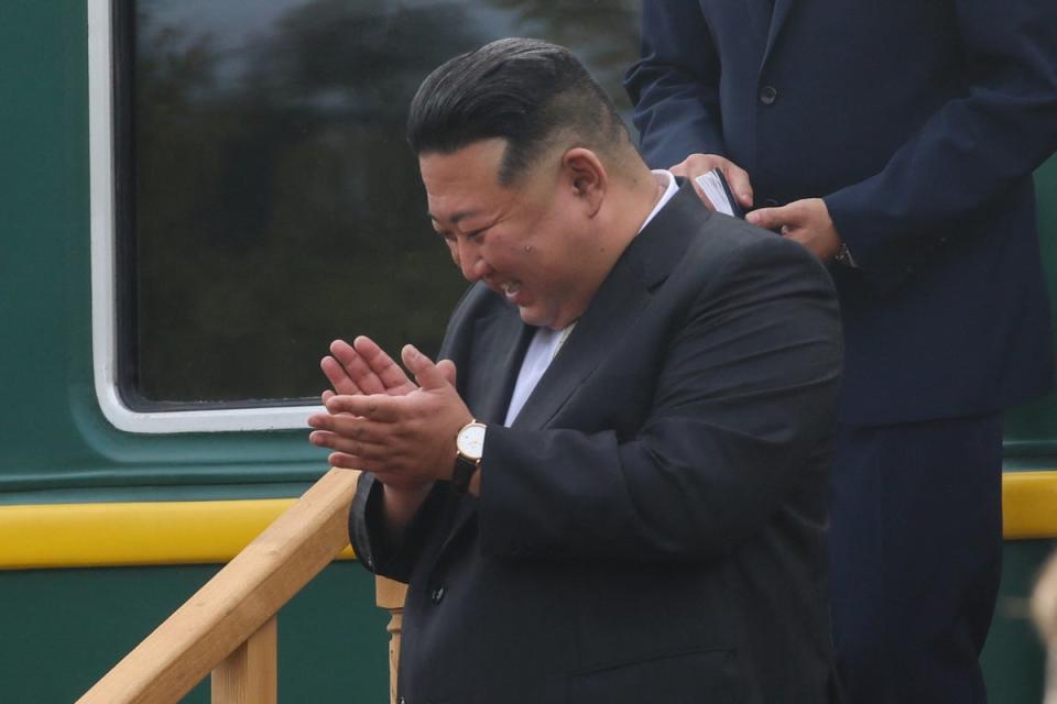 North Korean leader Kim Jong Un reacts during a welcoming ceremony upon his arrival at a railway station in the town of Artyom (via REUTERS)