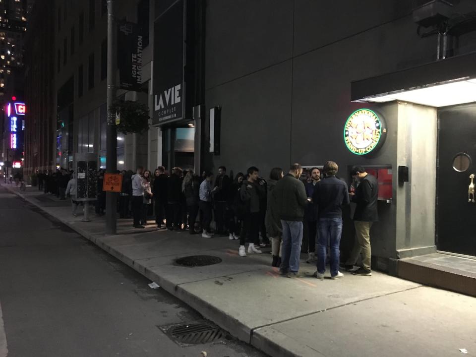 Fans wait in front of the Yuk Yuk's Comedy Club in Toronto ahead of Louis C.K.'s first night of shows there on October 2, 2019.