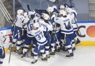 Tampa Bay Lightning players celebrate a win over the New York Islanders during overtime in Game 6 of the NHL hockey Eastern Conference final Thursday, Sept. 17, 2020, in Edmonton, Alberta. (Jason Franson/The Canadian Press via AP)