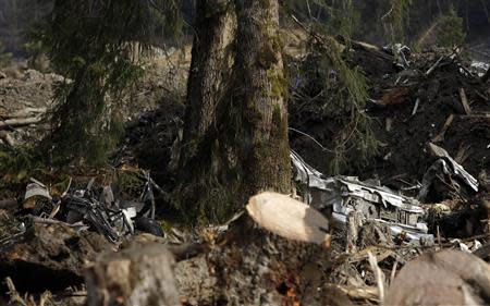 Vehicles are pictured in the mud and debris from a massive mudslide that struck Oso near Darrington, Washington April 2, 2014. REUTERS/Jason Redmond