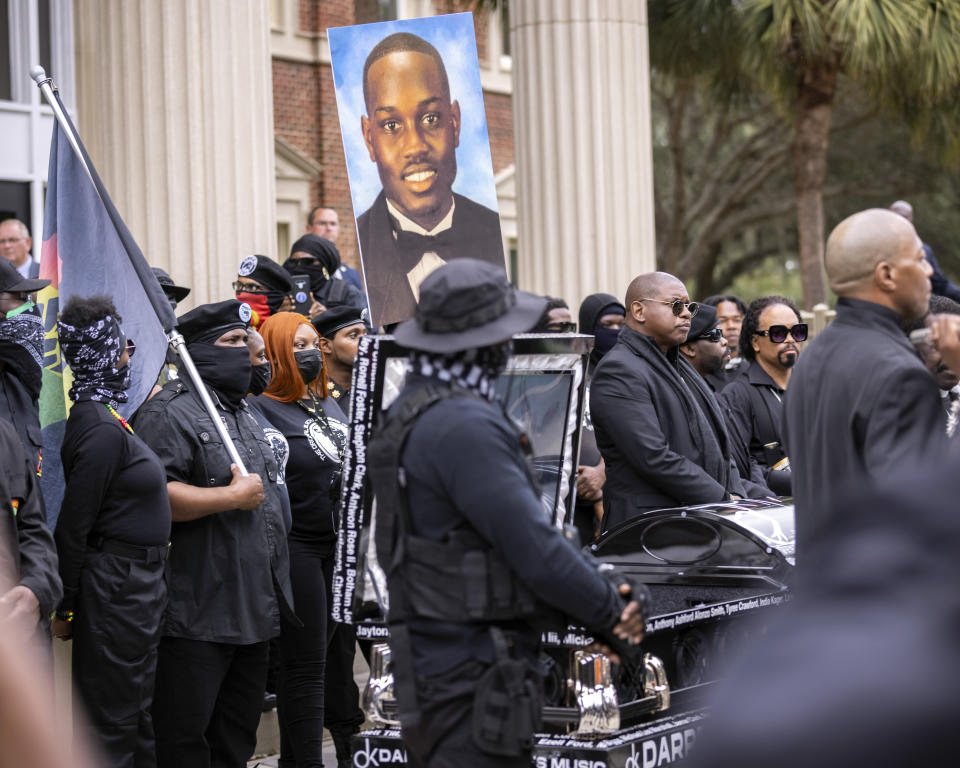 Dozens of Black Lives Matter and Black Panther protesters gather outside the Glynn County Courthouse where the trial of Travis McMichael, his father, Gregory McMichael, and William "Roddie" Bryan is held, Monday, Nov. 22, 2021, in Brunswick, Ga. The three men charged with the February 2020 slaying of 25-year-old Ahmaud Arbery. (AP Photo/Stephen B. Morton)