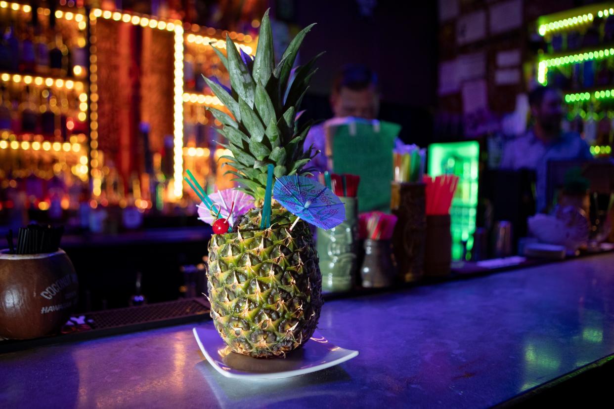 A Lost Pineapple, made with two rums, macadamia nut, coffee liquor, pineapple and lime sits on the bar at Monkey’s Paw Tiki Bar in Springfield.