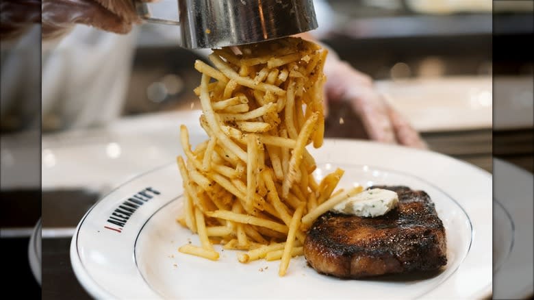 steak with pile of fries