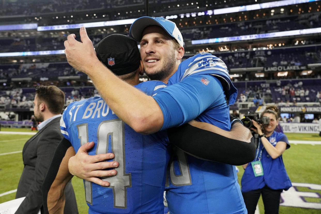 Lions quarterback Jared Goff, right, and wide receiver Amon-Ra St. Brown celebrate the Lions' 30-24 win on Sunday, Dec. 24, 2023, in Minneapolis, to clinch the NFC North Division.