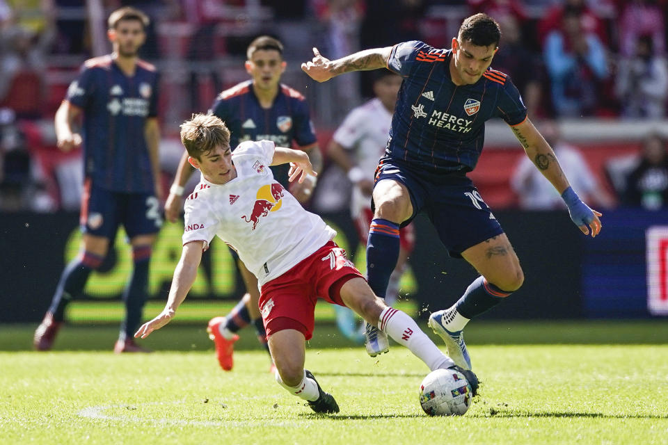 New York Red Bulls midfielder Daniel Edelman, left, vies for the ball with FC Cincinnati forward Brandon Vazquez (19) during an MLS playoff soccer match, Saturday, Oct. 15, 2022, in Harrison, N.J. (AP Photo/Eduardo Munoz Alvarez)