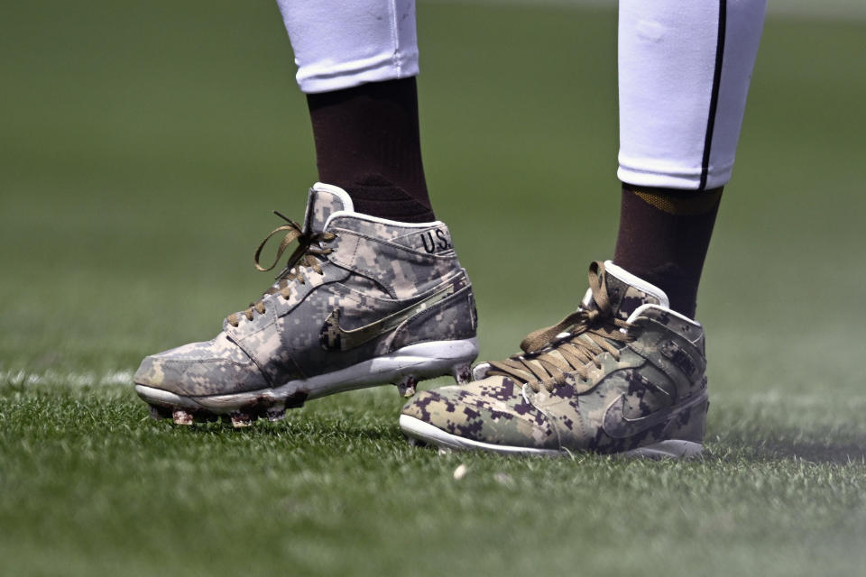 FILE - San Diego Padres outfielder Fernando Tatis Jr. wears cleats in honor of the U.S. military during the team's baseball game against the San Francisco Giants on March 31, 2024, in San Diego. Tatis Jr. plans to unveil 50 pairs of custom cleats this season.(AP Photo/Denis Poroy, File)