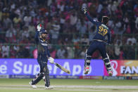 Gujarat Titans' Rashid Khan, left, and teammate Noor Ahmad celebrate their team's victory during the Indian Premier League cricket match against Rajasthan Royals in Jaipur, India, Wednesday, April 10, 2024. (AP Photo/Surjeet Yadav)