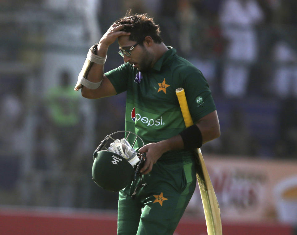 Pakistan's Imam-ul-Haq on his way to pavilion after being dismissed by Sri Lanka, in Karachi, Pakistan, Monday, Sept. 30, 2019. Pakistan play a second one-day international after winning the toss and elected to bat against Sri Lanka. (AP Photo/Fareed Khan)