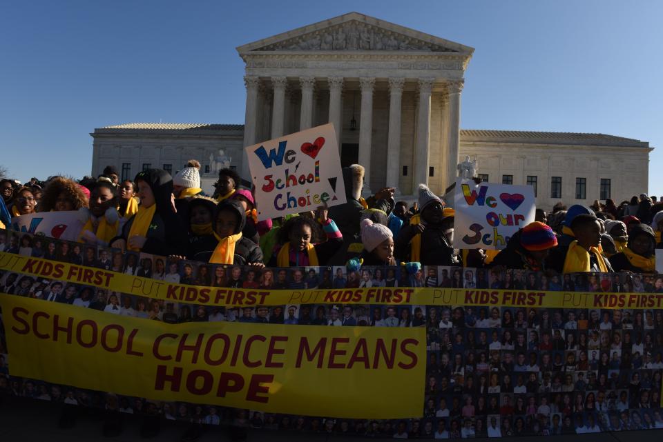 Demonstrators gather outside the Supreme Court on Jan. 22 as the justices hold oral argument in a case from Montana that could upend the funding balance between public and religious schools.