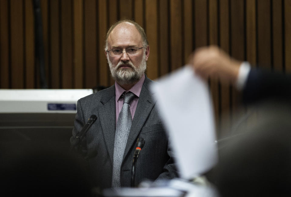 Forensic investigator Roger Dixon is questioned by state prosecutor Gerrie Nel, not pictured, during the murder trial of Oscar Pistorius in court in Pretoria, South Africa, Wednesday, April 16, 2014. Pistorius is charged with the murder of his girlfriend, Reeva Steenkamp, on Valentines Day in 2013. (AP Photo/Gianluigi Guercia, Pool)